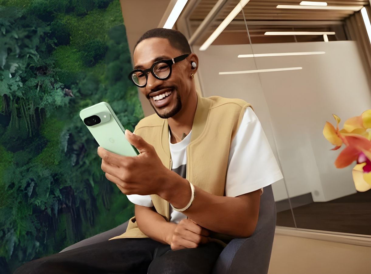 A founder smiling at his phone